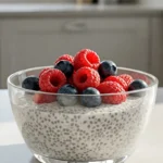 Creamy chia seed pudding topped with fresh berries in a bright kitchen