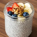 Chia pudding in a glass jar topped with fresh fruits and honey