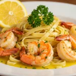 Shrimp scampi served over pasta with lemon and parsley